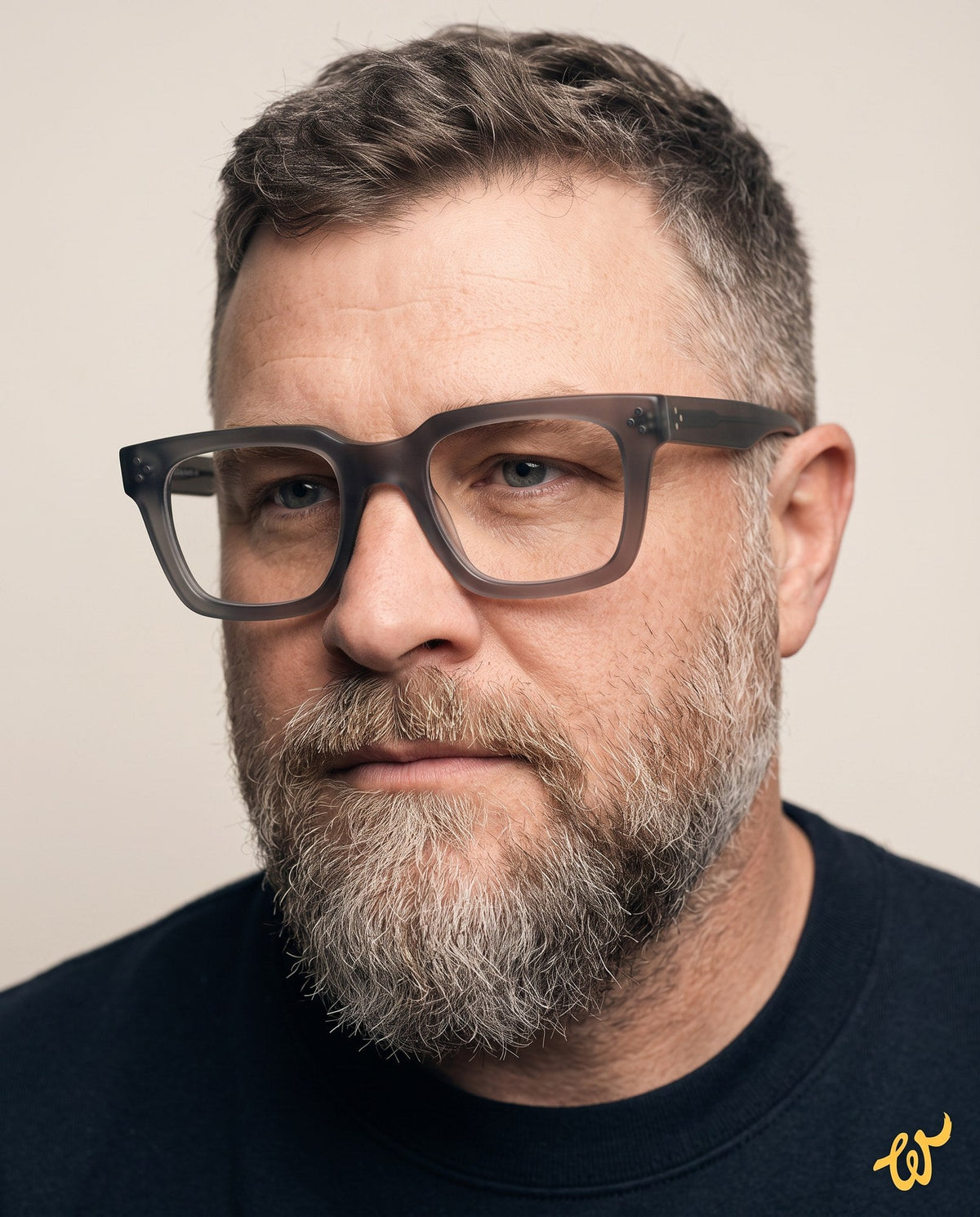 Man with a wide face wearing Woolet 009 Soft Square eyeglasses in silver clear