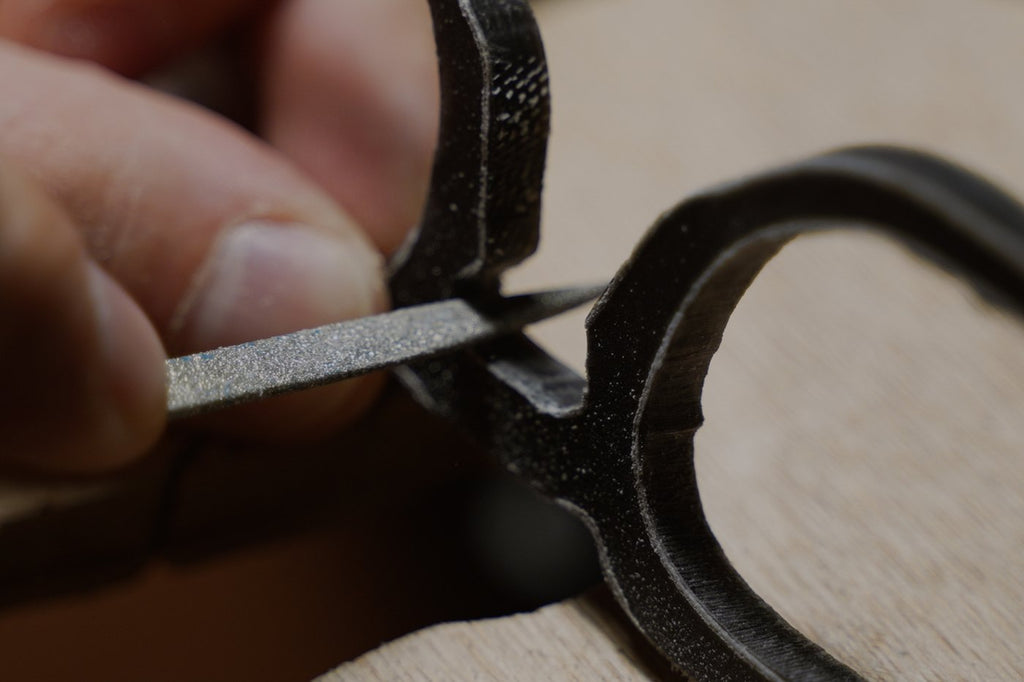 Woolet Bespoke - hands filing the bridge of an acetate frame, every pair cut to your measurements and hand made in Greece